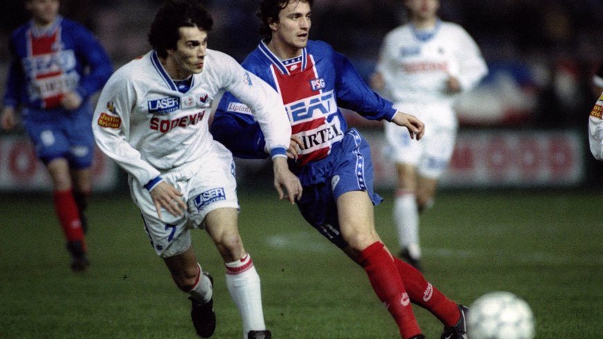 David Ginola of Paris Saint Germain soccer team (R) and Sassus of Lyon chase after the ball in their..